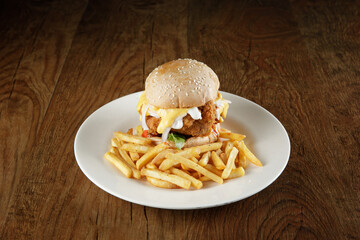 super delicious burger with melted cheese and french fries