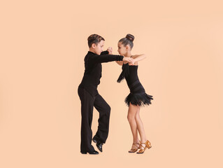Cute little children dancing against color background