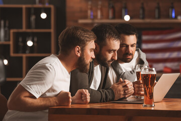 Men placing sports bets in pub