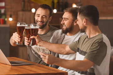 Happy men after winning of their sports bets in pub
