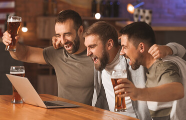 Happy men after winning of their sports bets in pub