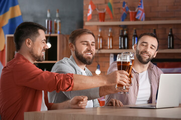 Happy men after winning of their sports bets in pub
