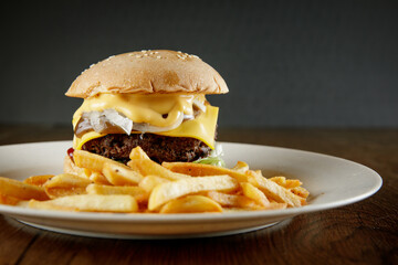 super delicious burger with melted cheese and french fries