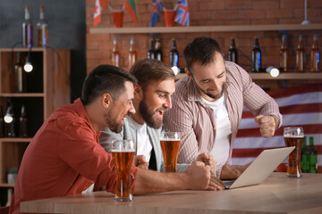 Happy men after winning of their sports bets in pub