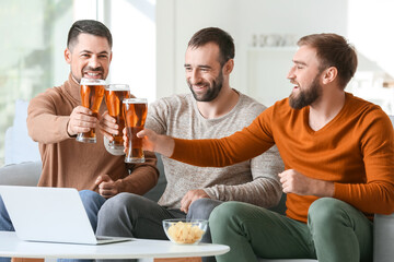 Happy men after winning of their sports bets at home