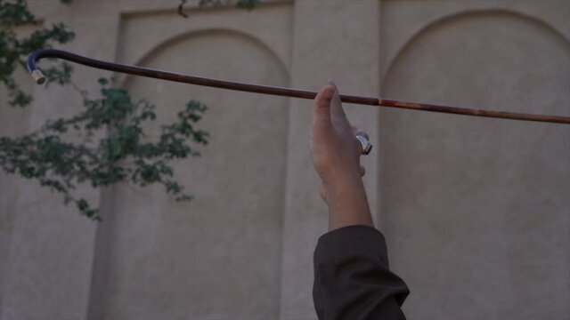Arabic man spinning stick yowla in slow motion