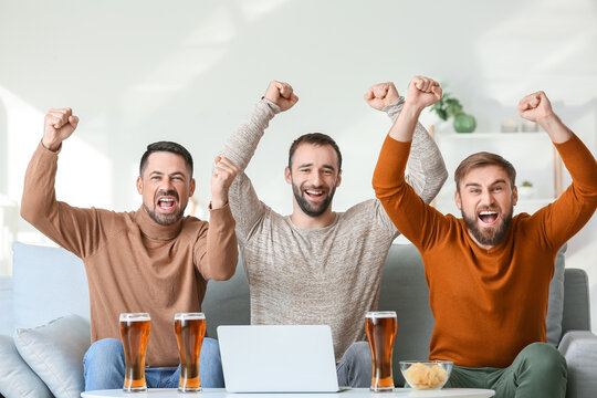 Happy men after winning of their sports bets at home