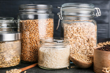Jars with assortment of cereals on table