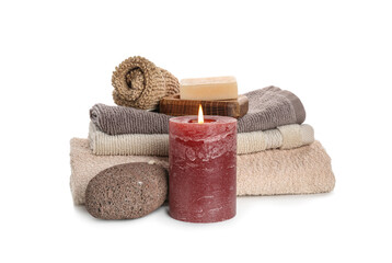 Aroma candle with bathing supplies on white background