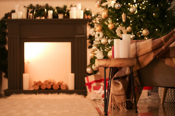 Candles in interior of living room decorated for Christmas