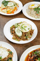 a plate of Fried noodle ( Mee Goreng Mamak ) with fried egg