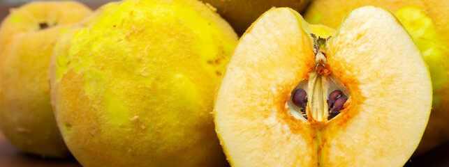 Quince fruit close-up on a wooden background.