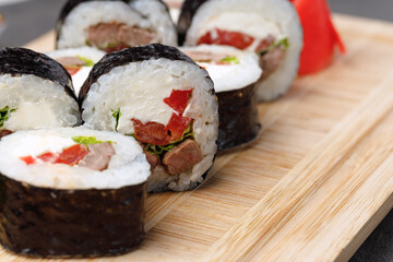 Maki sushi roll served on plate close up