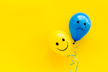 Fototapeta Positive and negative emotions background. Sad and happy faces on ballons obraz