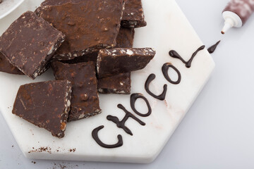 Broken or cracked chocolate chips pieces isolated on white background.