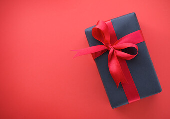 one gift with a red ribbon on a red background