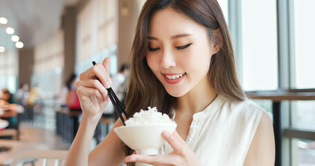 woman eat rice in restaurant
