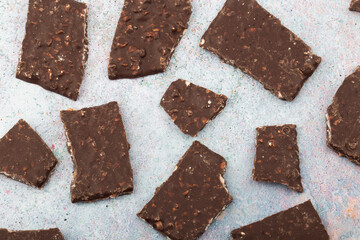 Broken chocolate chips pieces isolated on white background.