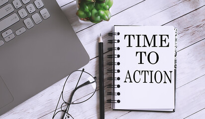 Notebook with TIME TO ACTION word with office tools, laptop on white table. business conceptual