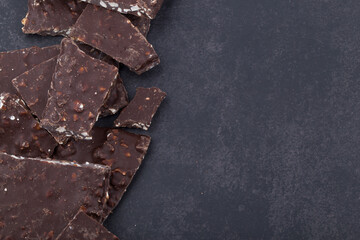 Broken chocolate chips pieces isolated on white background.
