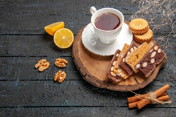 front view cup of tea with cookies and fruits on the dark desk ceremony sweet biscuits sugar