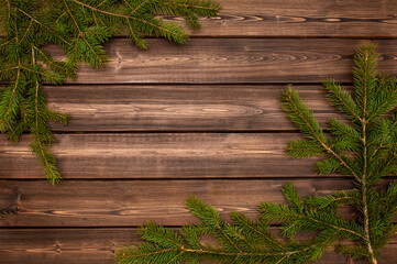 Christmas tree on a wooden background top view. Festive background for the new year 2021. Elegant card decor for Christmas greetings.