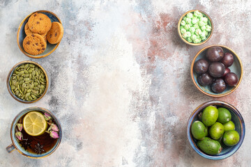 top view fresh fruits with cup of tea on light background tea photo dessert