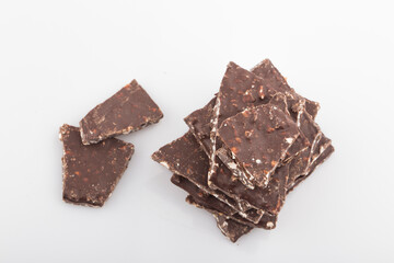 Broken chocolate chips pieces isolated on white background.