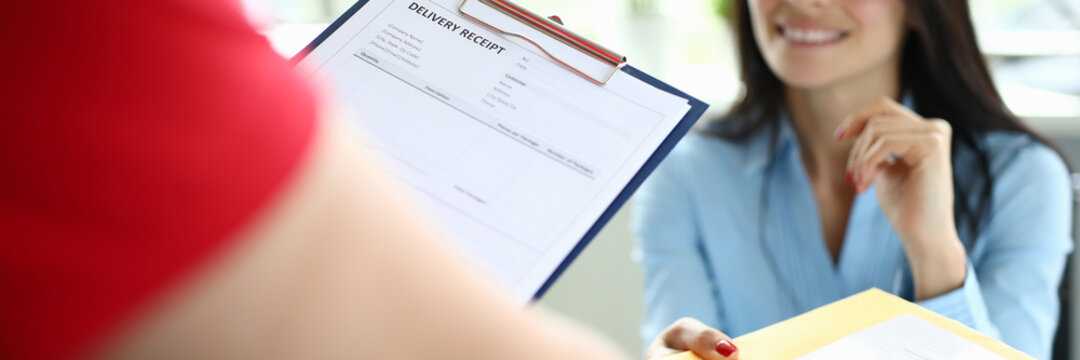 Courier delivers parcel mail to a businesswoman at her desk. Express mail delivery service by courier concept