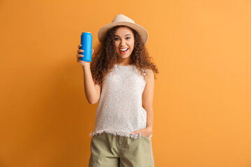 Beautiful African-American woman with soda on color background