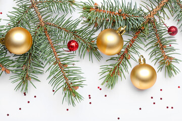 Fir tree branch with beautiful Christmas balls on white background