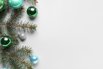 Fir tree branch with beautiful Christmas balls on white background