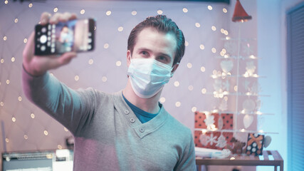 Quarantine Christmas selfie photo with surgical mask in 2020