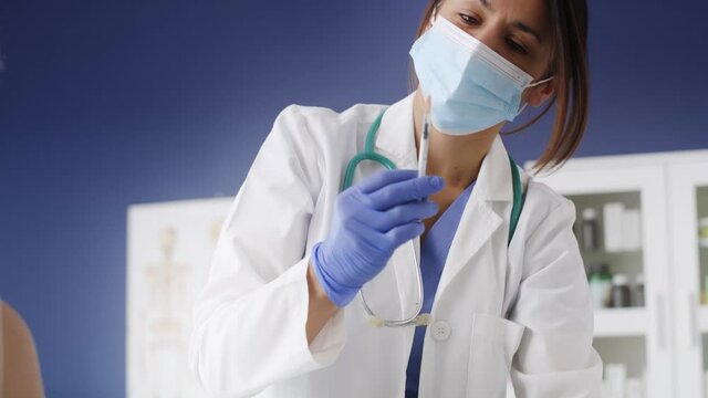 Handheld video of female doctor giving shot to patient. Shot with RED helium camera in 8K.