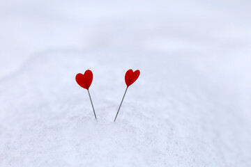 Two love hearts on a snow. Background for romantic greeting card, Valentine's day
