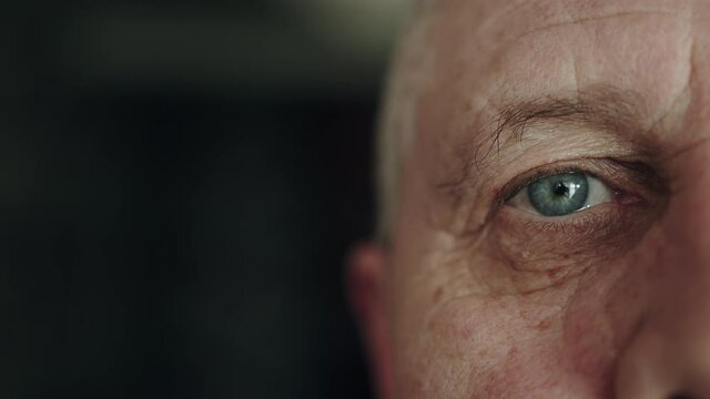 Close up of face senior man. Portrait of focused mature man. Close up of half face of upset caucasian elderly man. Shot in 6K