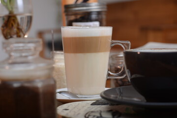 Hot cafe latte in glass with blur background, cafe photo concept.