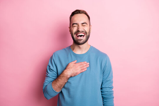 Photo of funky charming young guy wear blue pullover laughing arm chest closed eyes isolated pink color background