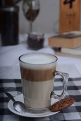 Hot cafe latte in glass with blur background, cafe photo concept.