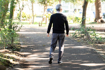 公園を一人で散歩する老人男性