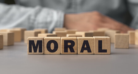 The word MORAL made from wooden cubes. Shallow depth of field on the cubes