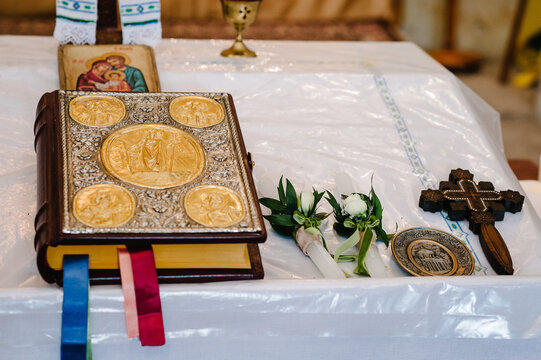 Holy Bible and cross on the table in the church. Divine Liturgy.
