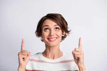 Close-up portrait of nice content cheerful brown-haired girl pointing forefinger up copy space look idea isolated over grey pastel color background