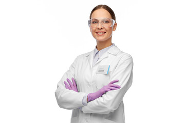 science and profession concept - happy smiling female scientist in goggles and gloves with nametag...