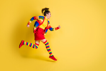 Full size profile side photo of crazy funky girl jump run wear rainbow skirt long socks isolated shine color background