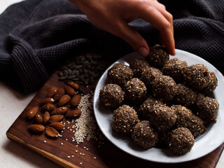 Seed and cardamom date balls in a rustic natural light setting