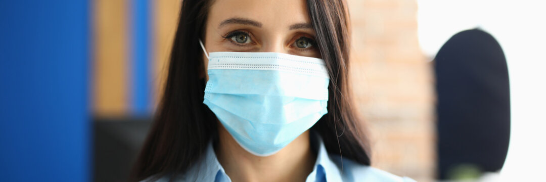 Portrait of businesswoman in protective medical mask in office. Virus and disease masks concept