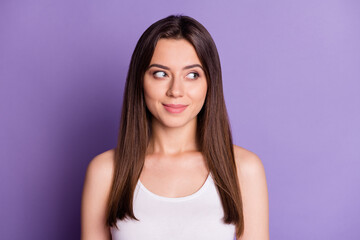 Photo portrait of smiling woman looking to side isolated on vivid purple colored background