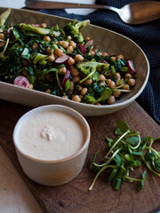 Rustic chickpea fresh green salad in bowl on table.
