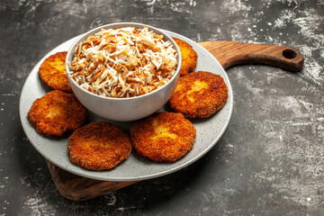front view delicious fried cutlets with cooked rice on a dark background dish meat rissole